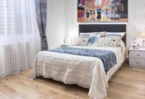a bedroom with a bed and a painting on the wall at Villa Marguerite in Coutras