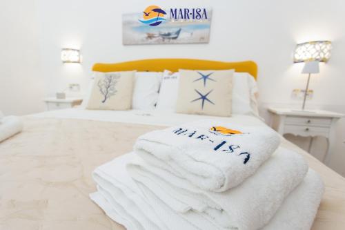 a pile of towels sitting on top of a bed at MAR-ISA Amalfi Coast in Vietri sul Mare