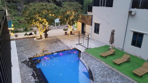 an overhead view of a swimming pool with two chairs at Trang An by Linh Homestay in Nguyên Ngoại