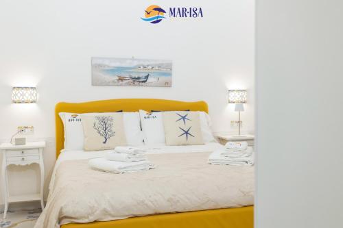 a bedroom with a bed with towels on it at MAR-ISA Amalfi Coast in Vietri sul Mare