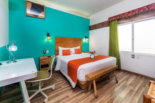 a hotel room with a bed and a desk and a desk at Collection O Casa Anzures Thematic, Mexico City in Mexico City