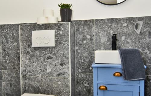a bathroom with a blue cabinet and a mirror at Vela Baraka by Villas Guide in Dragove