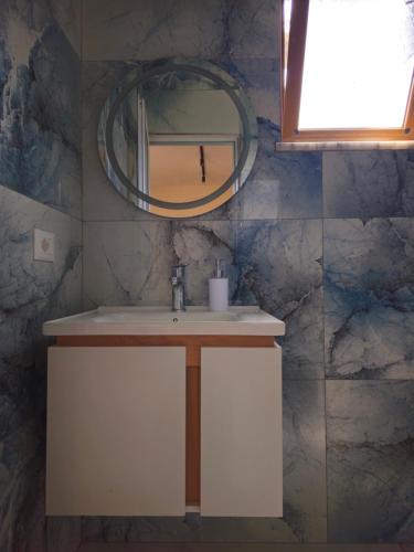 a bathroom with a sink and a mirror at Star Room's in Durrës