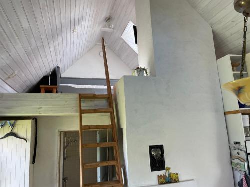 a room with a ladder in the middle of a room at Paradiset Östra Öland in Nedra Sandby