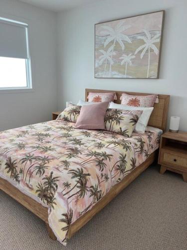 a bedroom with a bed with a palm tree blanket at Laguna Beach House Ocean Grove-pets welcome in Ocean Grove