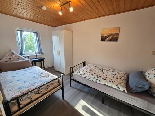 a bedroom with two beds and a window at Ferienhaus Doris in Heimbach