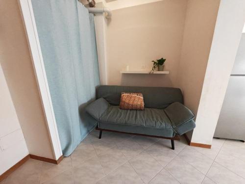 a couch with a pillow on it in a room at La Casina in Cecina