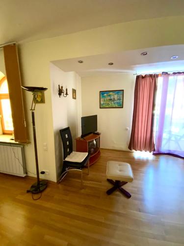 a living room with a desk and a chair at Heviz Gracia Apartment in Hévíz