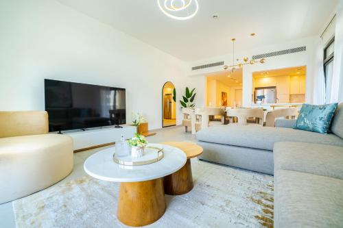 a living room with a couch and a table at Peaceful 2BR Retreat Near Burj Al Arab in Dubai