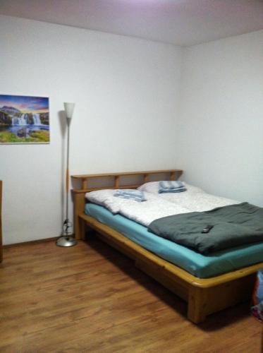 a bedroom with a bed and a lamp in it at Ferienidyll Zwiesel in Zwiesel