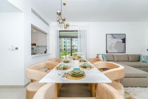 a living room with a table and chairs at Peaceful 2BR Retreat Near Burj Al Arab in Dubai