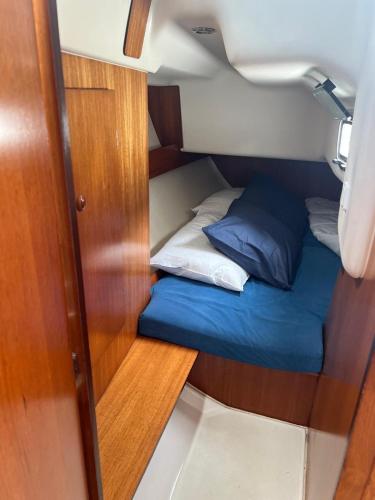 a small room with a bed and pillows on a boat at DeepBlue sail boat in Lisbon