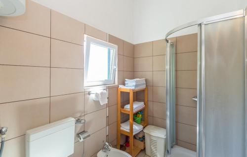 a bathroom with a shower and a toilet and a window at Apartman Tara - Makarska by Villas Guide in Makar