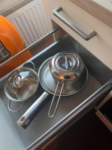 three pans sitting on a stove in a kitchen at Frankenberg-am-Wald Frankenberg an der Eder in Frankenberg