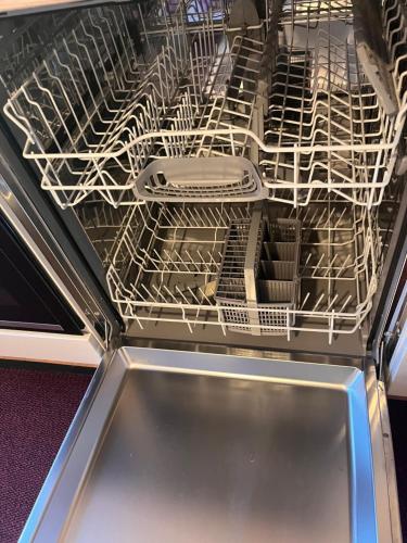 a dishwasher is open with a white dish rack at Frankenberg-am-Wald Frankenberg an der Eder in Frankenberg
