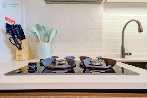 a kitchen stove top with three pots on it at Bright & Luxury Studio with Balcony in Al Furjan in Dubai