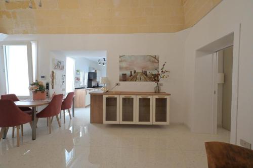 a kitchen and dining room with a table and chairs at Casa di nonna Pina in Manduria