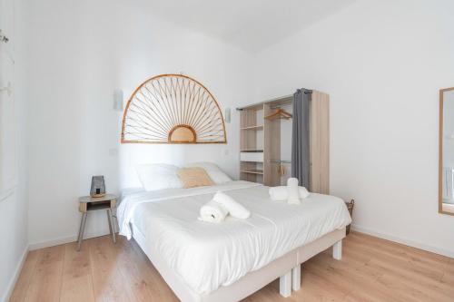a bedroom with a large white bed with white sheets at Appartement spacieux, chaleureux & tout confort in Pertuis