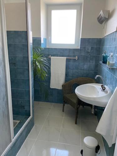 a bathroom with a sink and a shower at Pinabre Farmhouse in Plouguenast Langast