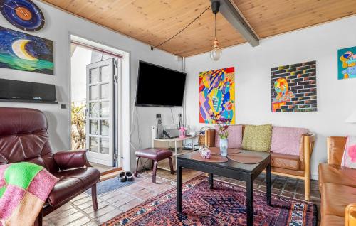 a living room with a couch and a table at 3 Bedroom Cozy Home In Store Fuglede in Store Fuglede