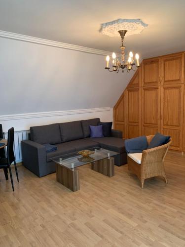 a living room with a couch and a table at Heviz Gracia Apartment in Hévíz