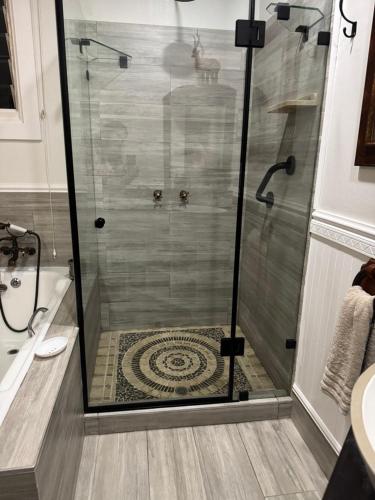 a shower with a glass door in a bathroom at Seaforth Country House in Ballito
