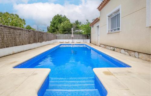 a swimming pool in the backyard of a house at Stunning Home In L'ametlla De Mar in L'Ametlla de Mar