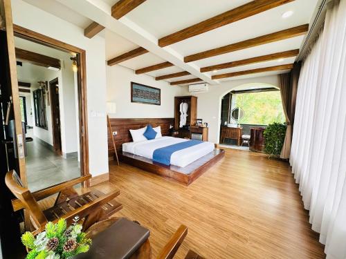 a bedroom with a bed and a desk in a room at Sapa Pine Hill Eco Lodge in Sa Pa