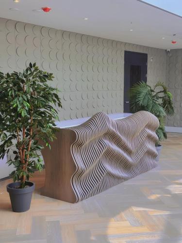 a room with two potted plants and a bed at Nebula Hotel by Ine's in Assendelft
