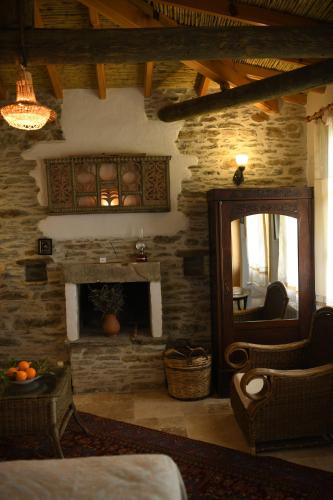 a living room with a fireplace and a mirror at Nisanyan Hotel in Selcuk