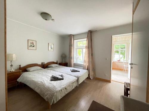 a bedroom with a bed and a large window at Haapsalu Guesthouse in Haapsalu