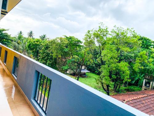a view from the balcony of a house with trees at Shelo Transit Hotel in Katunayake