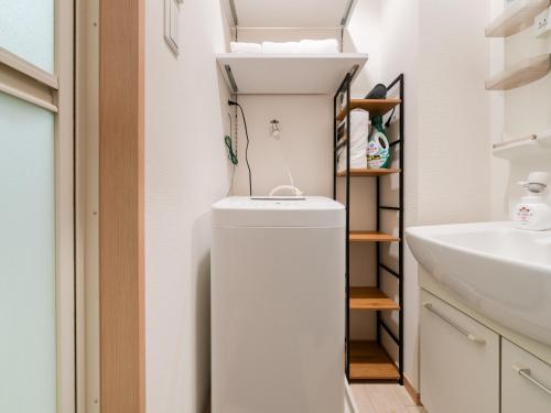 a small bathroom with a sink and a toilet at Ikebukuro 10 min-Family-Friendly Stay-Mobile Wi-Fi&Switch-Net in Tokyo