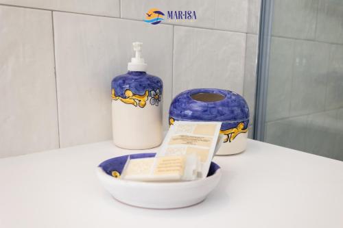 a bathroom with a bottle of disinfectant and a container of soap at MAR-ISA Amalfi Coast in Vietri sul Mare