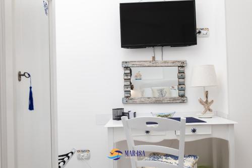 a desk with a tv and a chair in a room at MAR-ISA Amalfi Coast in Vietri sul Mare