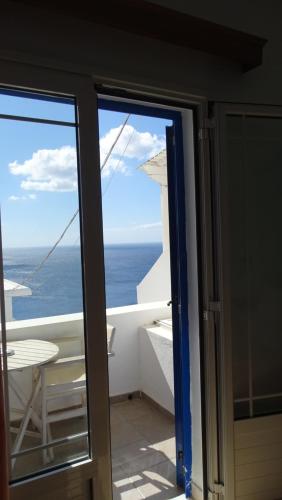 a view of the ocean from the balcony of a house at Hermes-Ios Rooms To Let in Ios Chora