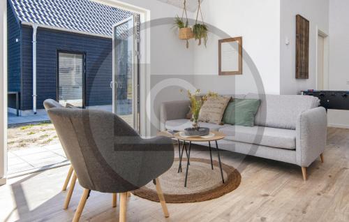 a living room with a couch and a table at Gorgeous Home In Glesborg in Glesborg