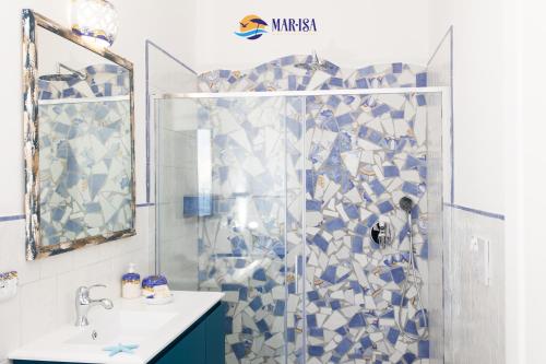 a bathroom with a shower with blue and white tiles at MAR-ISA Amalfi Coast in Vietri sul Mare