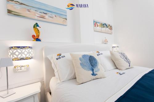 a bedroom with a white bed with pillows at MAR-ISA Amalfi Coast in Vietri sul Mare