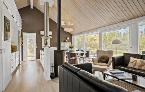 a living room with a couch and a table at Gorgeous Home In Brovst With Sauna in Brovst