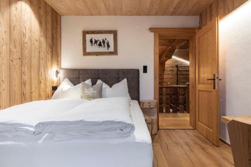 a bedroom with a large bed with white sheets at Chalet LAUDEGG in Ladis