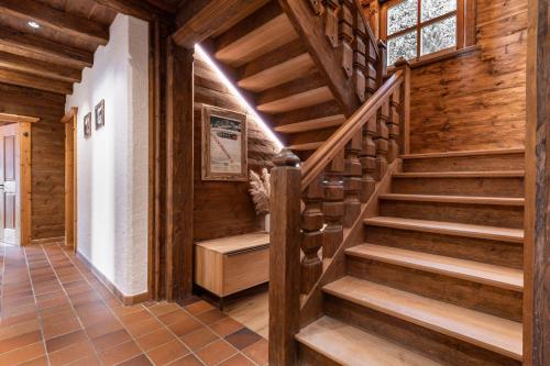 a staircase in a house with wooden walls and floors at Chalet LAUDEGG in Ladis