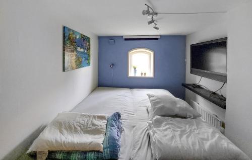 a small bedroom with a bed and a window at Gorgeous Home In Ängelholm With Wifi in Ängelholm