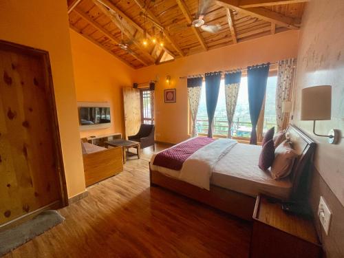 a bedroom with a bed and a large window at Sangita Resorts in Nainital