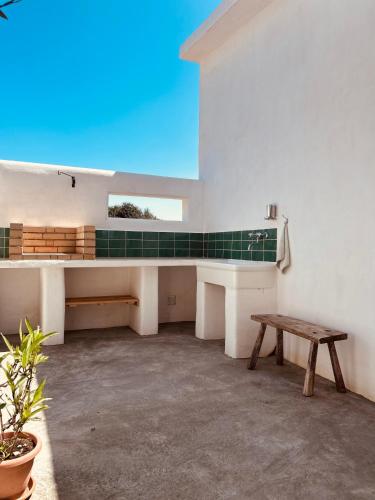 a room with a bench and a table at Dream Holiday in Marina di Lizzano