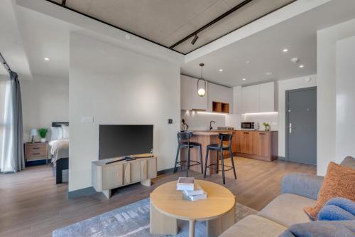 a living room with a couch and a table at Chic Luna Apartments near Wembley Park by MySquare in London