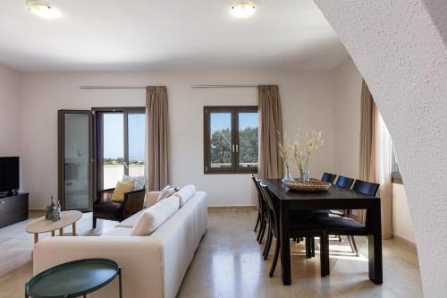 a living room with a couch and a table at Mithonies Villa, with Private Pool & BBQ, By ThinkVilla in Margarítai
