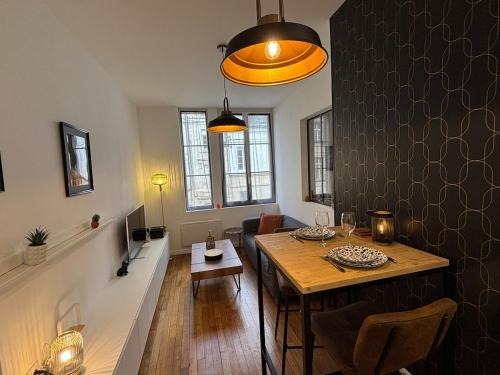 - un salon avec une table à manger et une salle à manger dans l'établissement Le Saint André Hyper centre ville, à Saint-Quentin