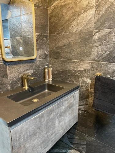 a bathroom with a sink and a mirror at Brock cottage Tideswell newly modernised in heart of Peak District National Park in Tideswell