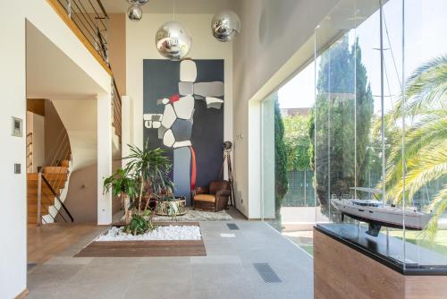 a living room with a large glass door and a room with at Villa BAHIA Sète - Luxury Villa - Beachfront in Sète